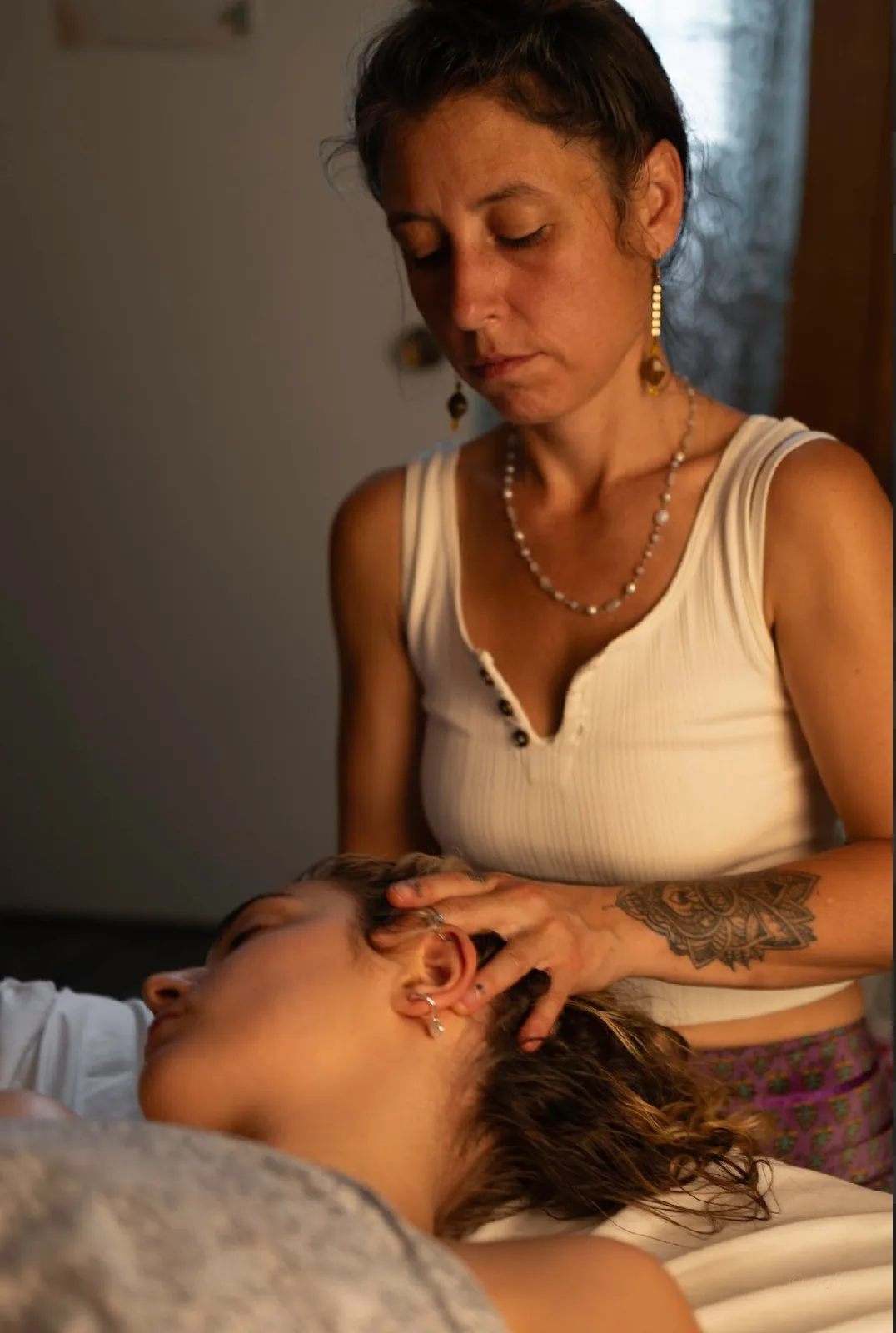Melissa providing gentle head and neck massage in her studio